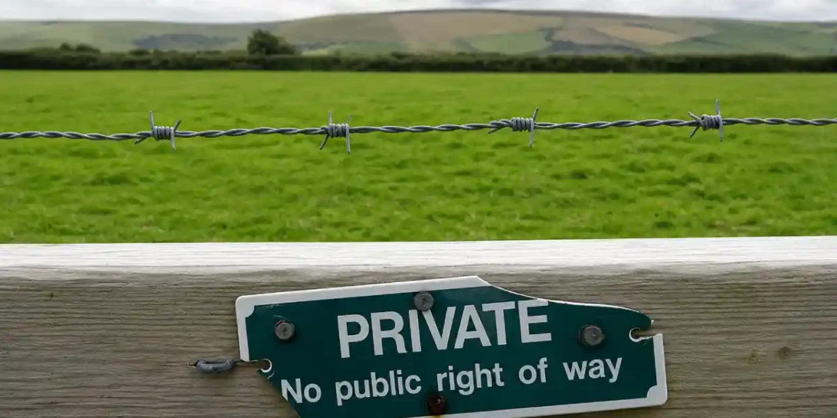 Private property sign on a rural fence with barbed wire.