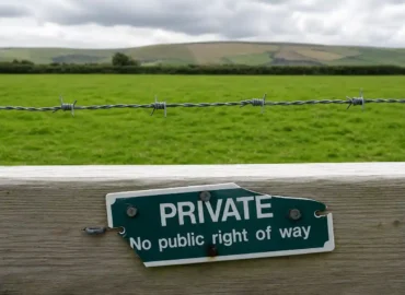 Private property sign on a rural fence with barbed wire.