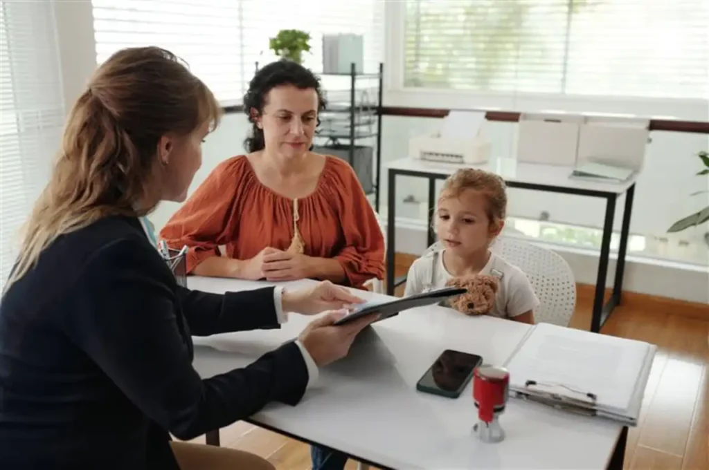 Child with mother in a lawyer’s office, with a lawyer explaining an agreement, representing child support.