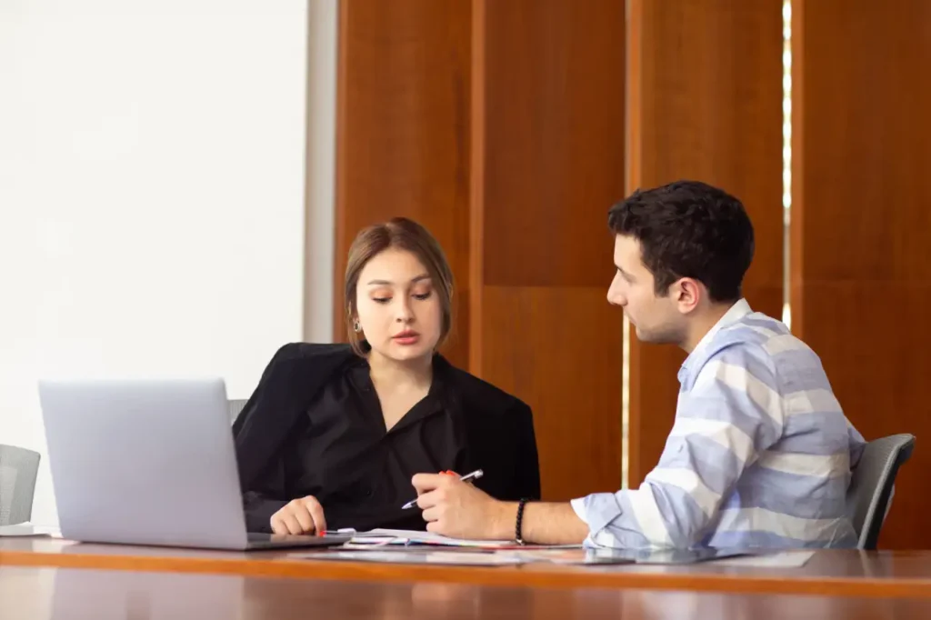 Legal Requirements bfa A Lawyer consulting with a client during a legal meeting in an office.