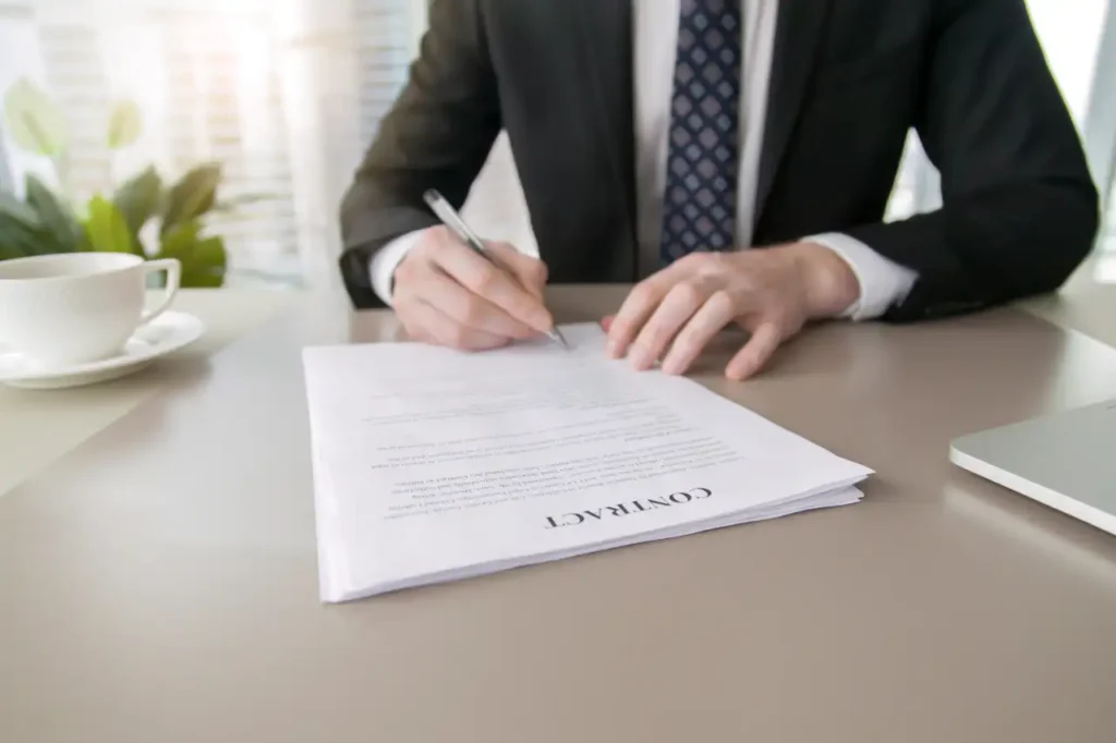 Power of attroney Lawyer signing a power of attorney document during a legal consultation.